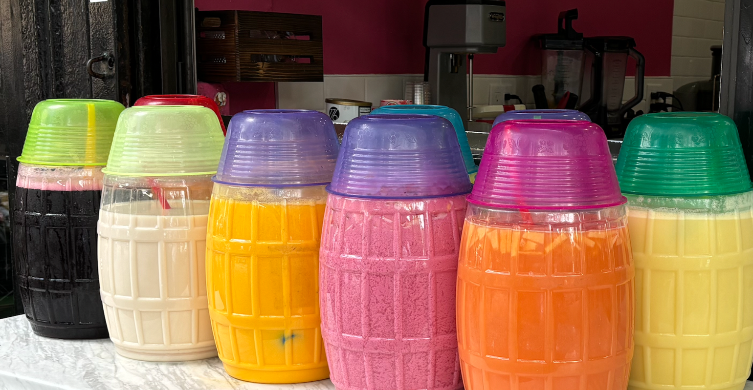 clear plastic barrels will brightly colored juices inside