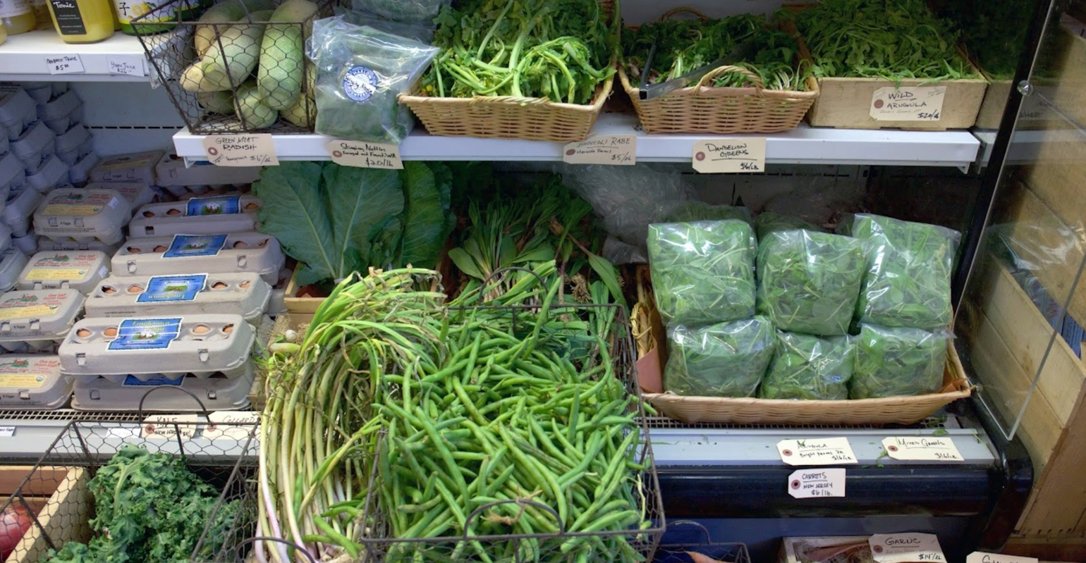 produce fridge full of green vegetables