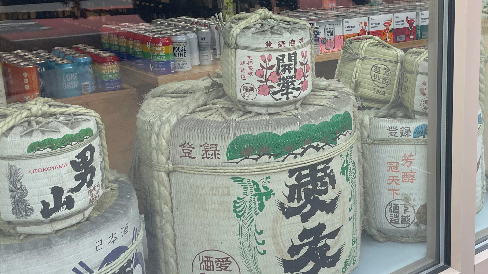 traditional sake barrels stacked in a shop window