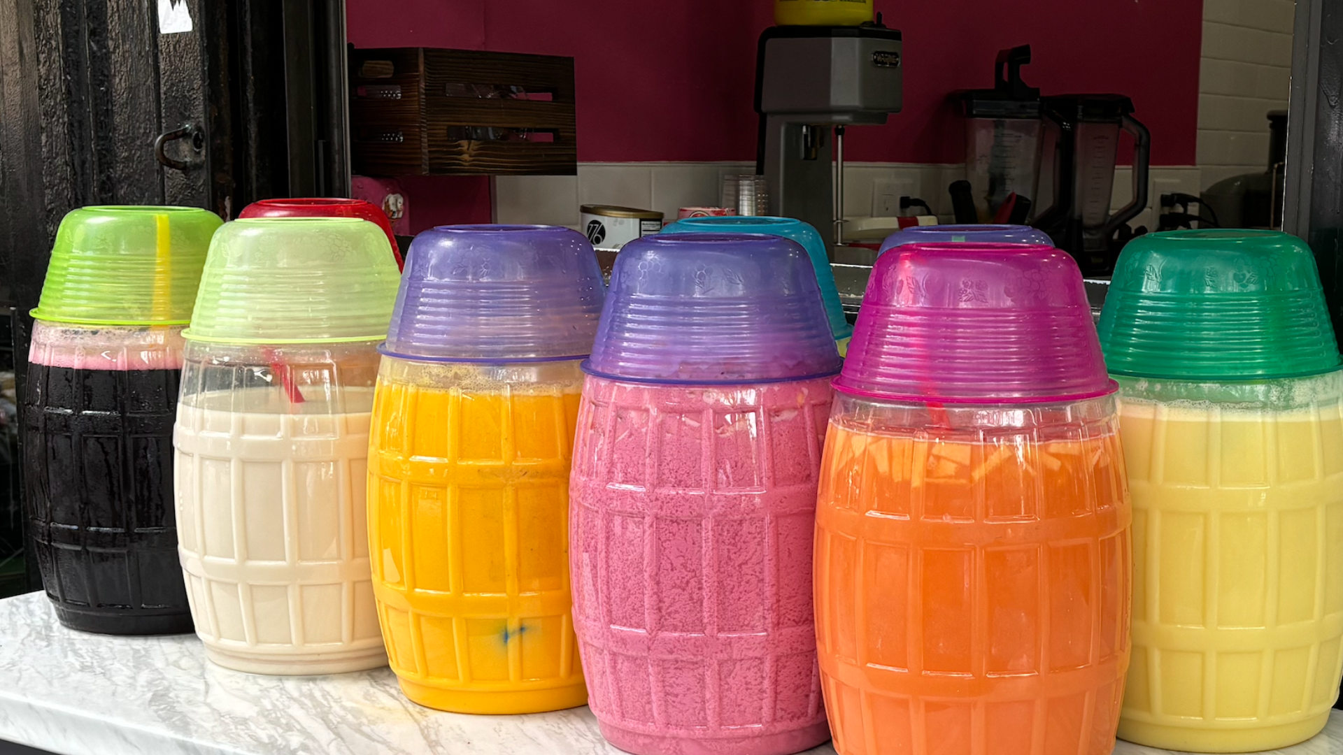 clear plastic barrels will brightly colored juices inside