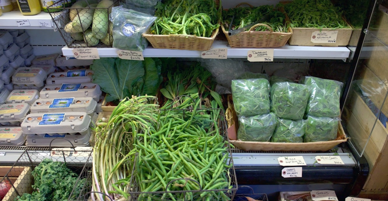 produce fridge full of green vegetables