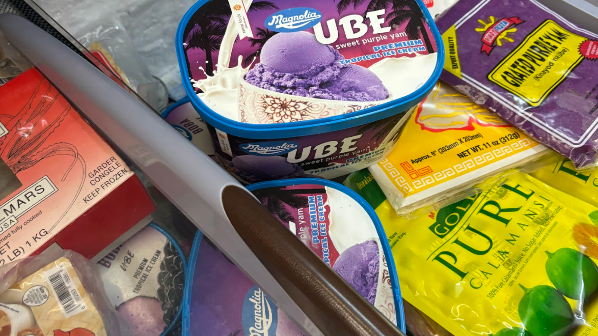 detail of an ice cream freezer with frozen ube and calamansi products